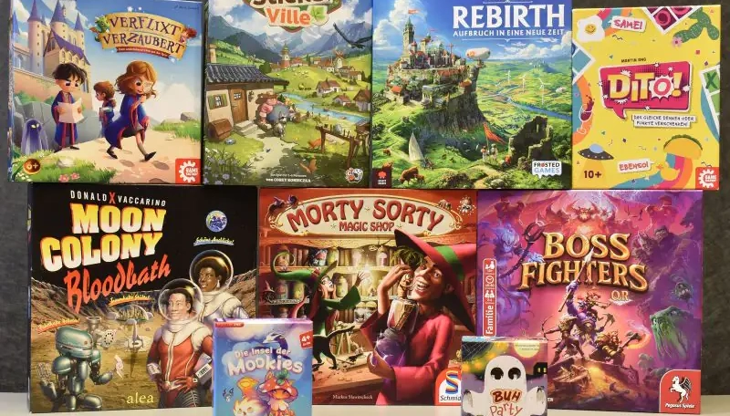 Mehrfarbige Brettspiele zur Nominierung „Spiel des Jahres 2026“: Rebirth, Cozy Stickerville, Verflixt verzaubert, Dito!, Moon Colony Bloodbath und Boss Fighters QR.