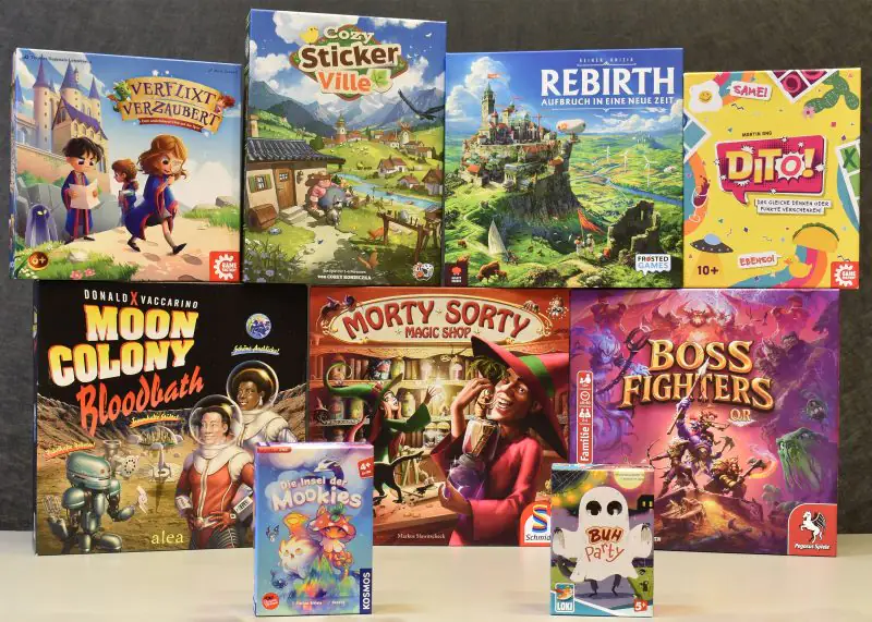Mehrfarbige Brettspiele zur Nominierung „Spiel des Jahres 2026“: Rebirth, Cozy Stickerville, Verflixt verzaubert, Dito!, Moon Colony Bloodbath und Boss Fighters QR.